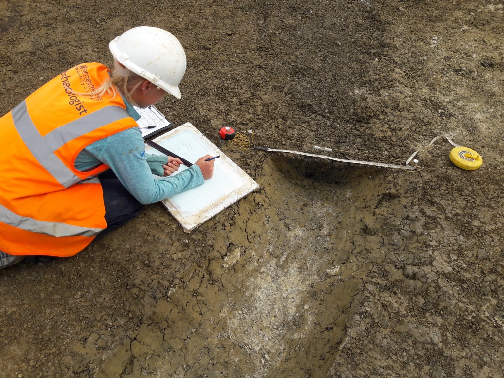 Archaeologist recording roundhouse gully