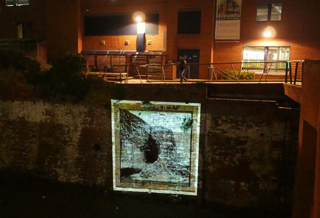 Square light projection onto historic city wall