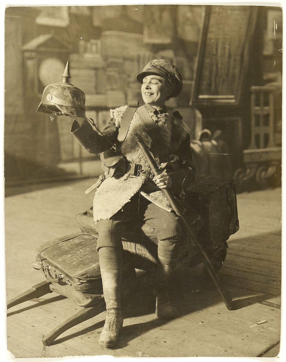 Vesta Tilley performing during WWI in army uniform, specially made for her, and with a captured German helmet