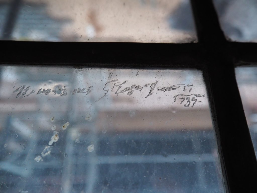 Graffiti etched into a window