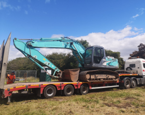 A digger being delivered to site