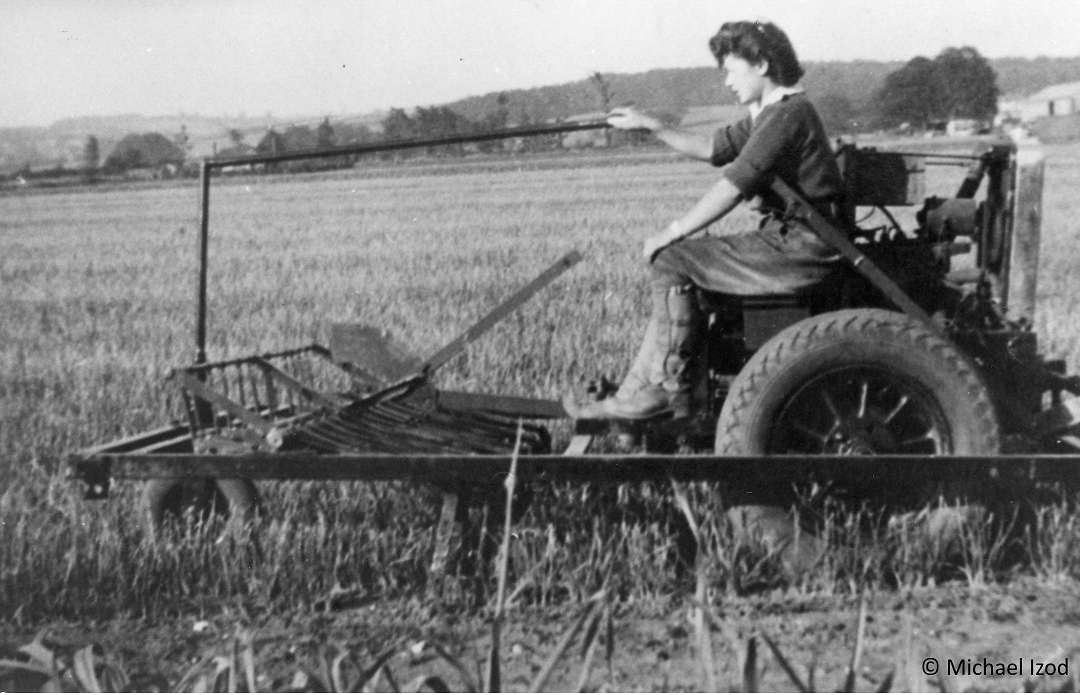 Land girls driving a hoeing machine