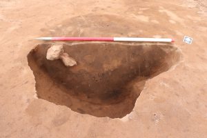 An image of the pit with fired clay and charcoal in the lower fills