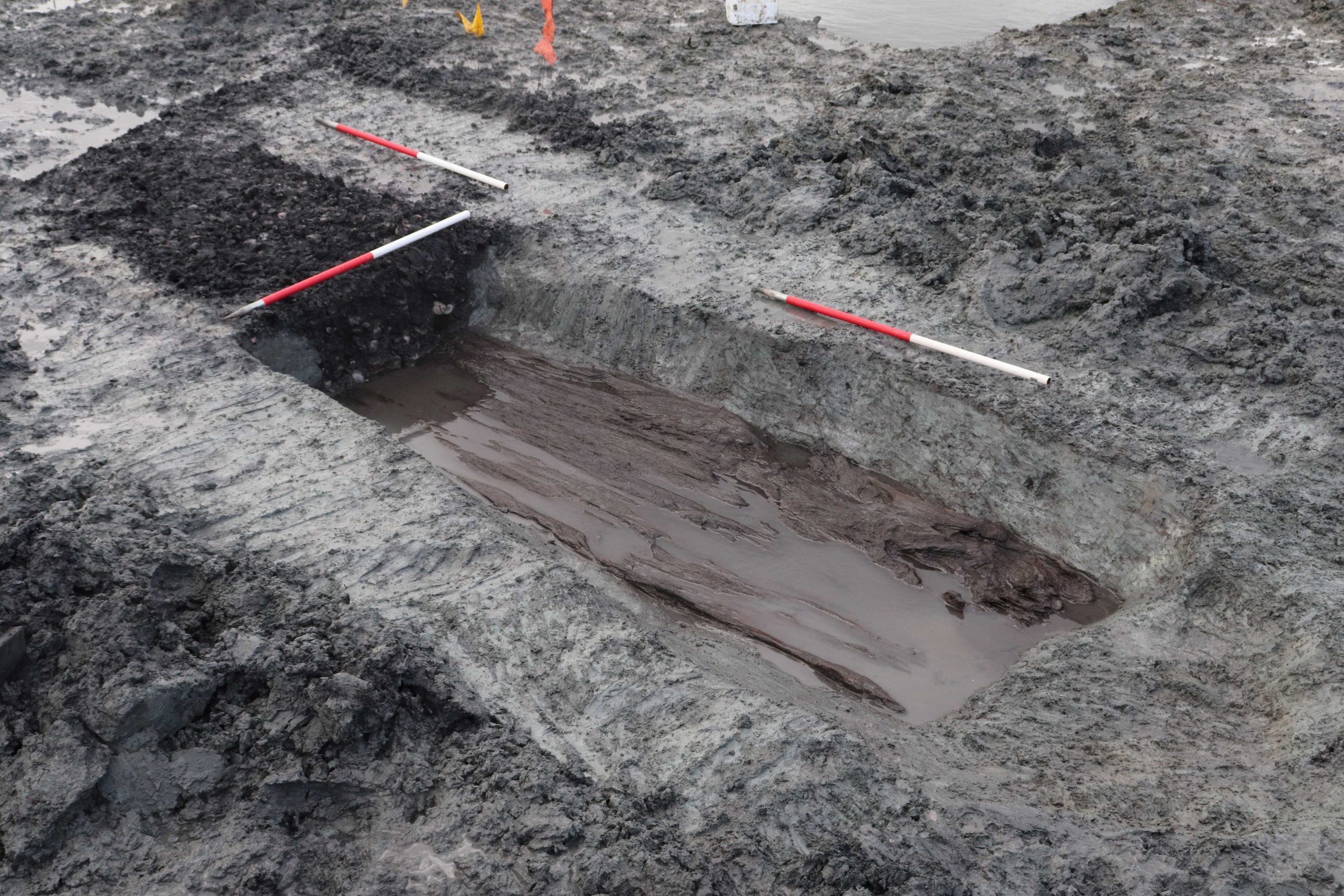 Base of a large wooden trough that's been filled with burnt material