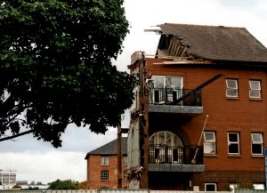 Picture of the territorial army building midway through demolition.