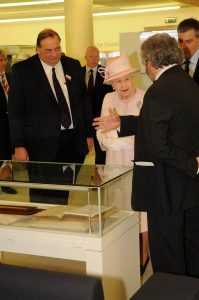 Adrian showing the queen something in a display