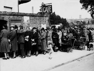 Old black and white photograph of people in a line