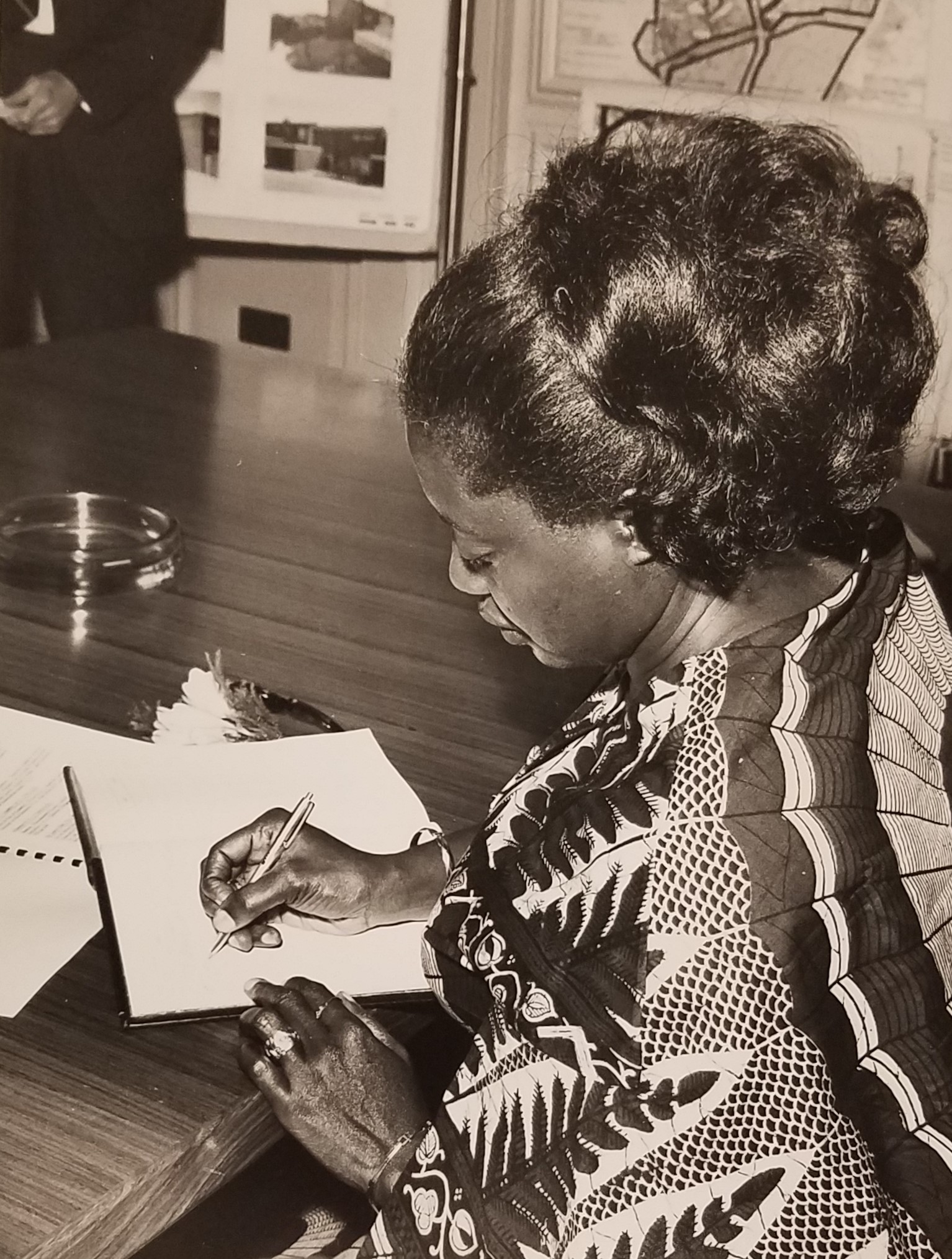 Victoria Poku, wife of Otomfuo Opoku Ware II. Signing Redditch Development Corporation visitors' book. Crown Copyright. 