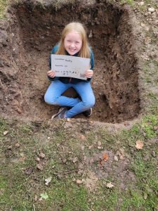 Child sitting in a test pit