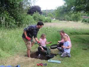 A family checking soil for finds