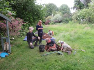 A group digging a test pit