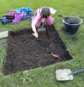 Child digging a test pit