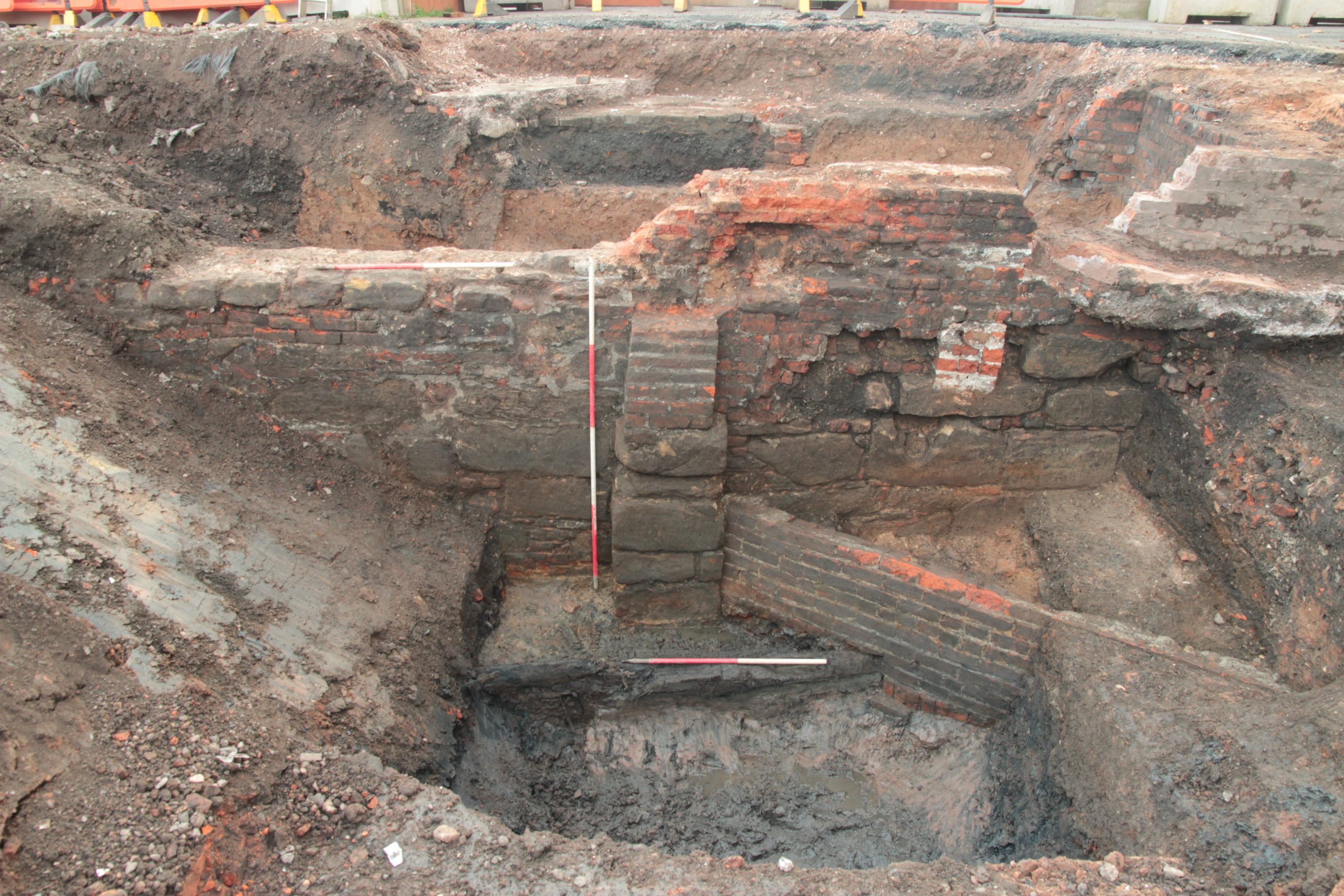 Later curtain wall with buttresses cutting off original eastern arm of moat