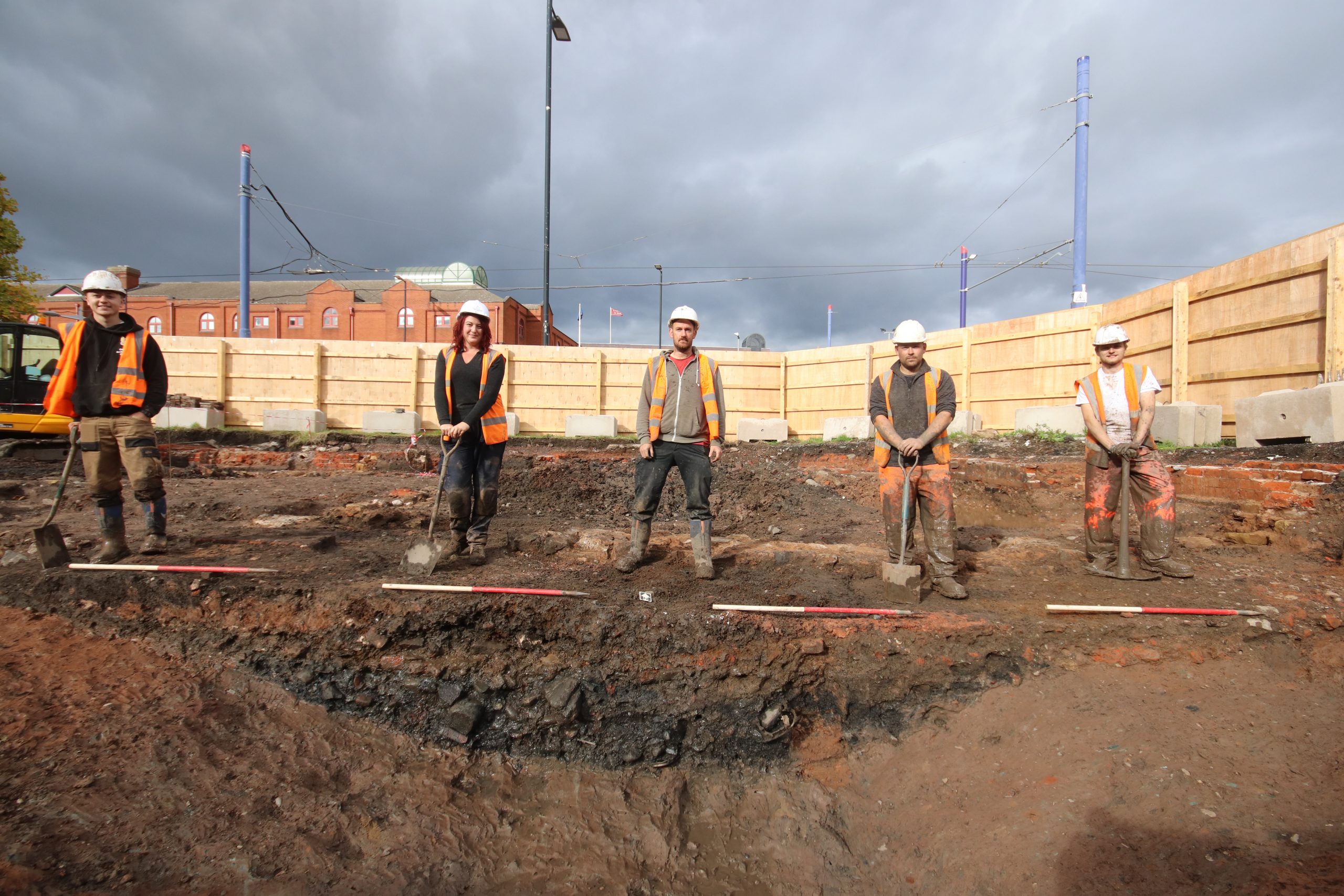 Five archaeologist with 1m deep moat extension