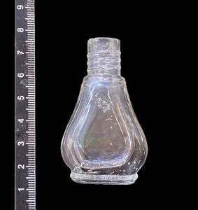 Small, curved clear glass bottle of Odorono