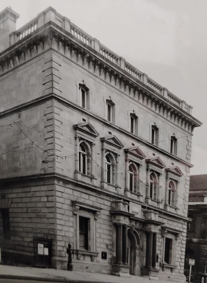 Three storey stone building with a grand facade.
