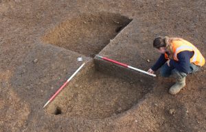 Archaeologist placing scales on a Saxon SFB ready to take photographs