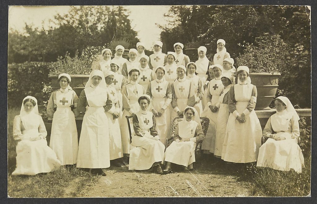 A digitised black and white image of a photograph showing nurses in uniform in the grounds of Battenhall Mount Vountary Aid Detachment Hospital
