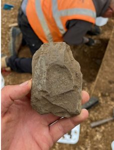 Partial polished stone axe being held