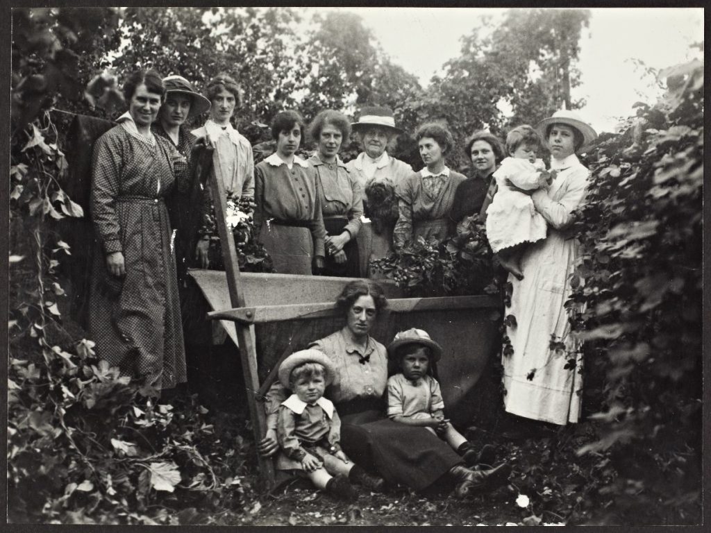 A digital image of a black and white photograph showing women pictured having taken part in Hop-picking in Harvington in 1917.