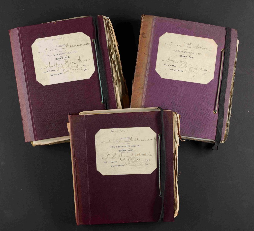 A set of three paper and board covered Bankruptcy case files with black braided elastic copyright Worcestershire County Court