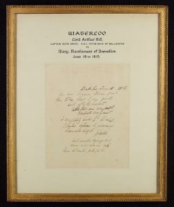 A handwritten letter in a gold frame from Lord Arthur Hill to his mother written after the Battle of Waterloo