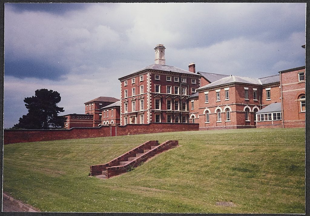 Long red brick building at Powick Hospital with large stash windows