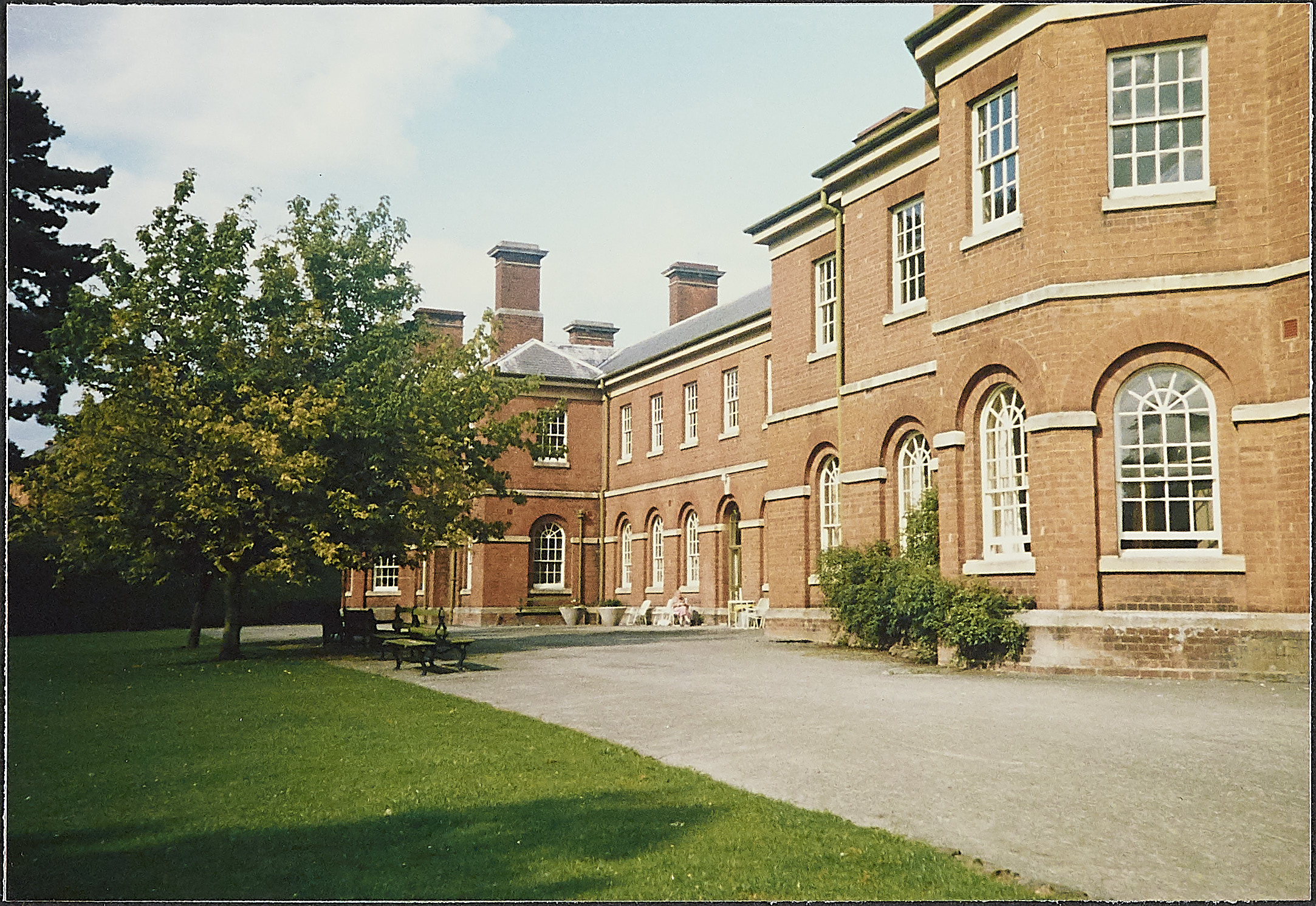 Long red brick building at Powick Hospital with large stash windows