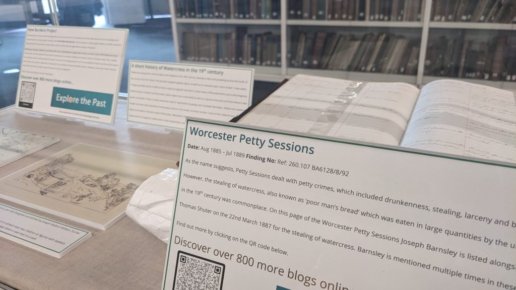 Display of printed material in a glass exhibition case including original volume which concerns Petty Sessions court records held at Worcestershire Archives and Archaeology Service