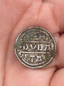 Silver coin in person's hand