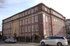 A colour photograph of a red brick munipal building.