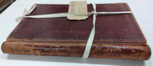 Colour photograph of the outside of a minute book bound in archival tape